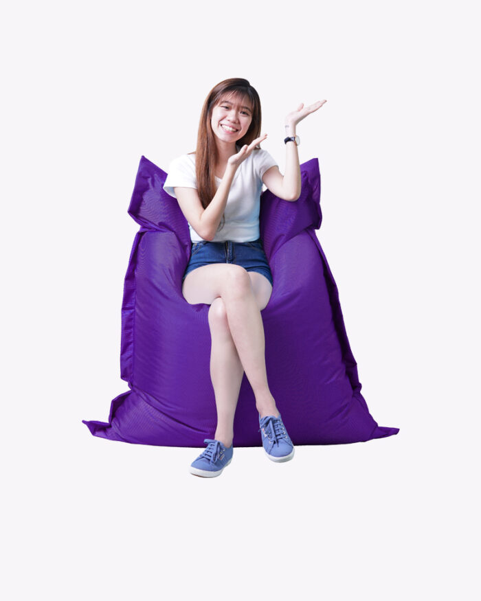 a woman sitting on a purple bean bag