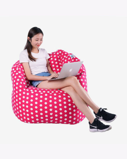 a woman sitting in a red polka dots bean bag