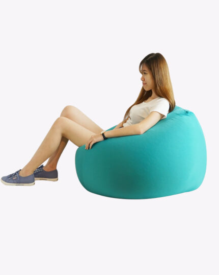 woman sitting on a turquoise bean bag