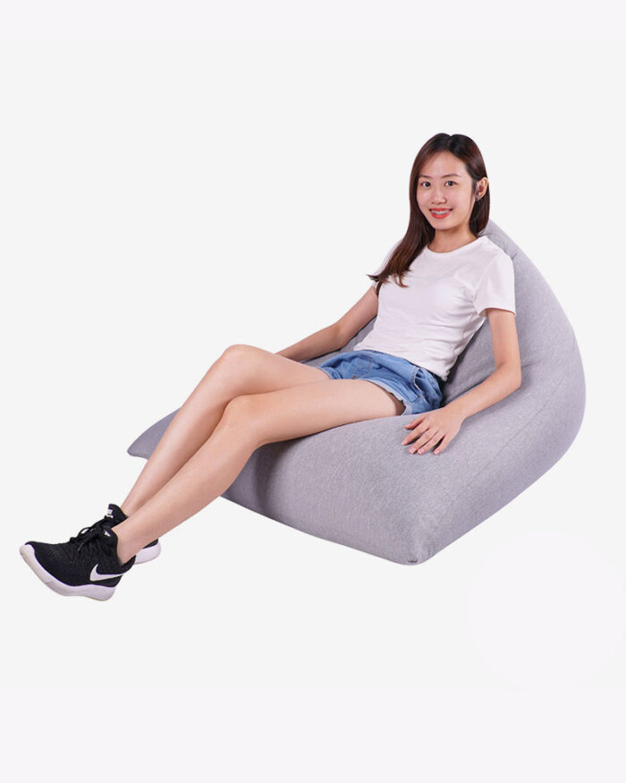a woman sitting comfortably on large grey fabric bean bag