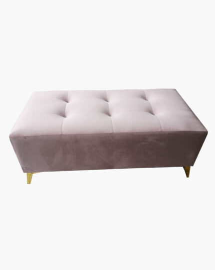 pink ottoman made from velvet fabric with tuftings and gold painted legs